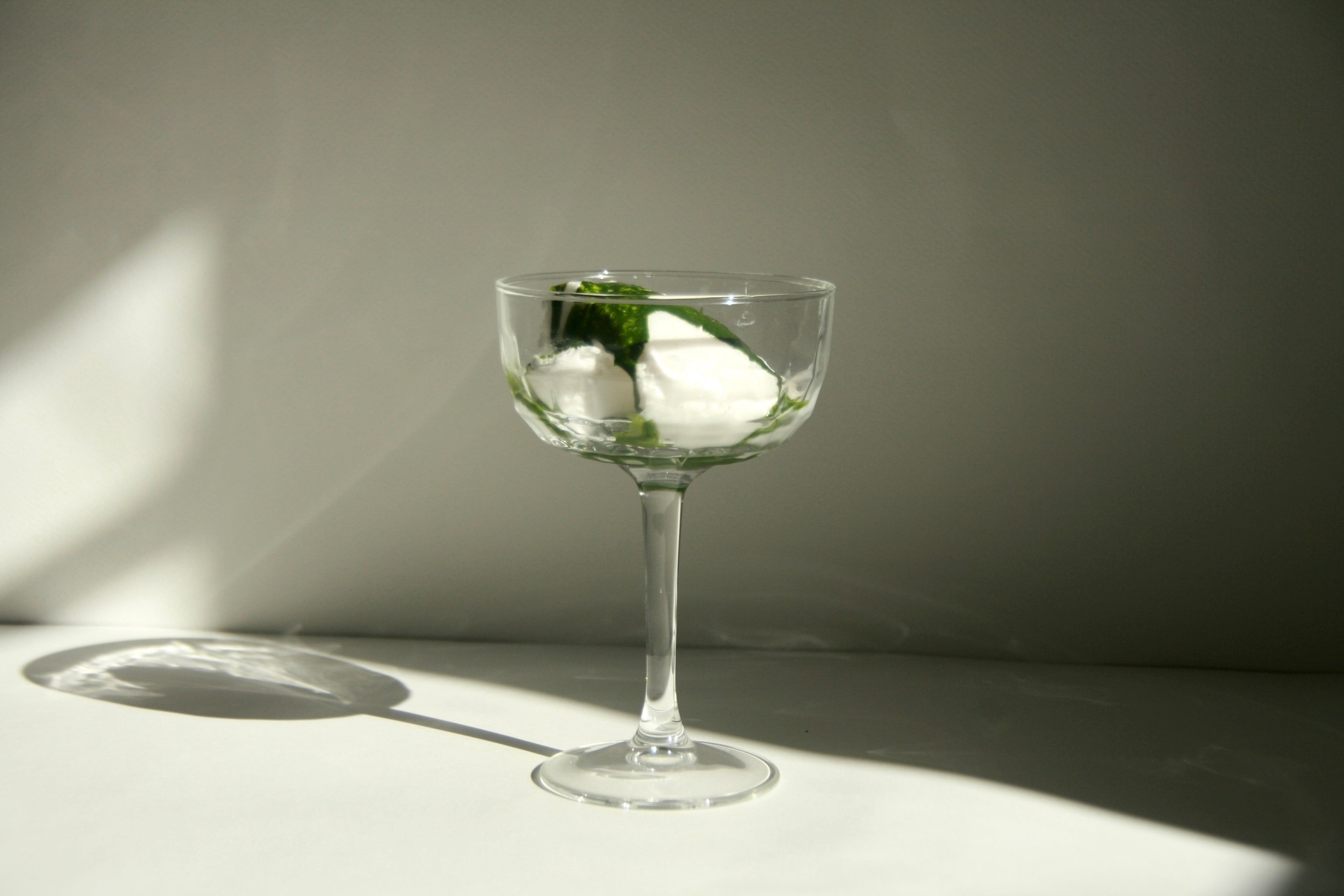 Kyuka Matcha dessert with green tea and ice cream in a clear glass on a minimalist background